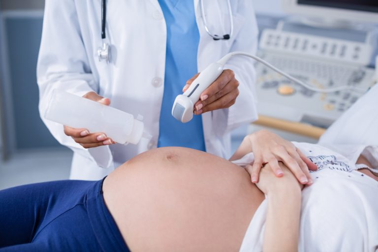 pregnant-woman-receiving-ultrasound-scan-stomach
